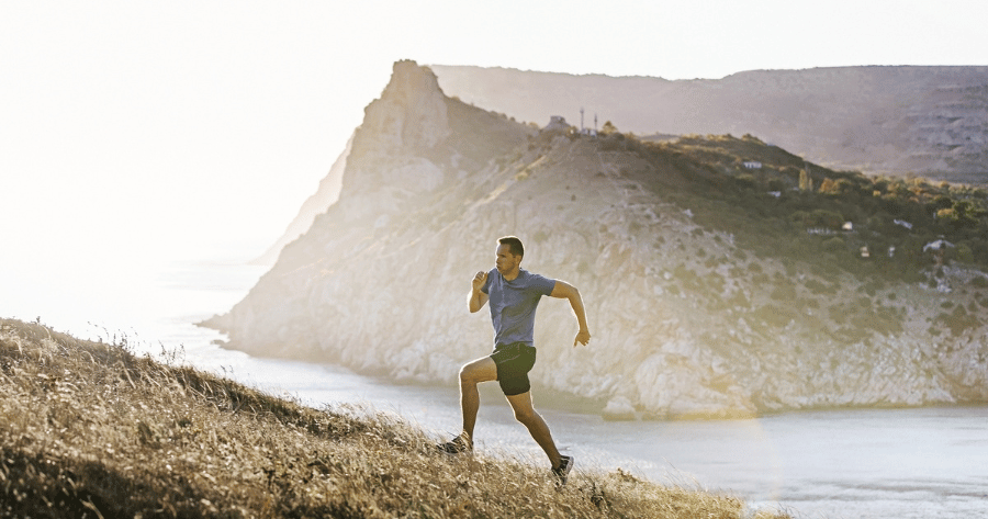 Calenadrio trail running errori da evitare in un paesaggio conm un trail runner che corre in salita al tramonto