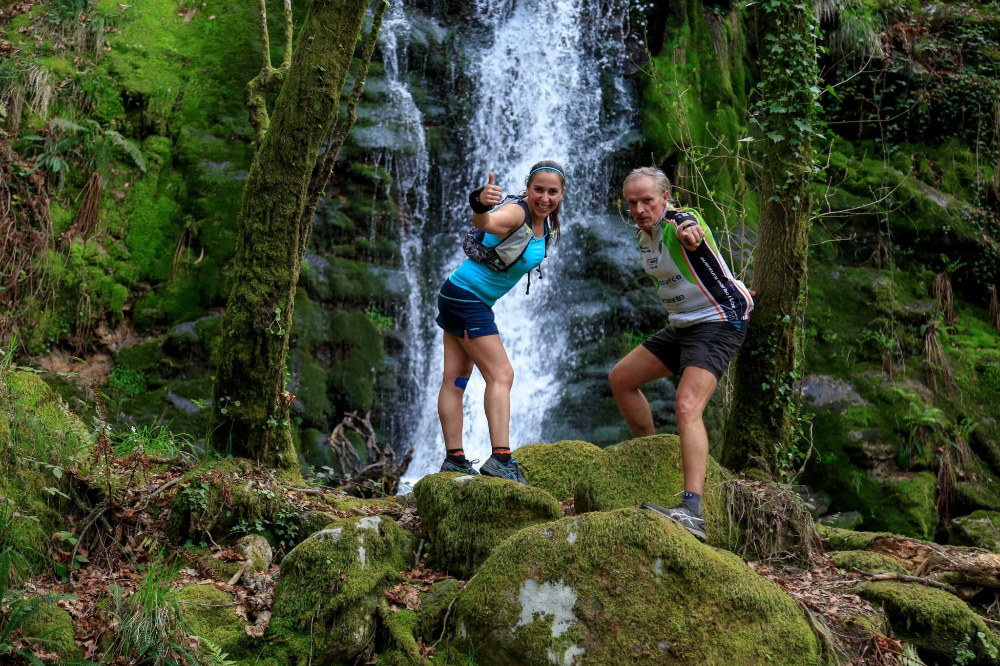 two trail runners in front of Goiva waterfall at Marao ultra trail