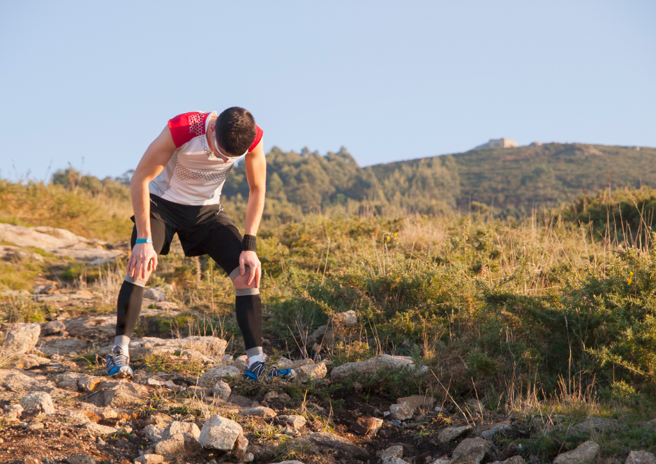 A trail runner is at his maximum effort, facing a psicholgical crisis and stand ons a trail alone