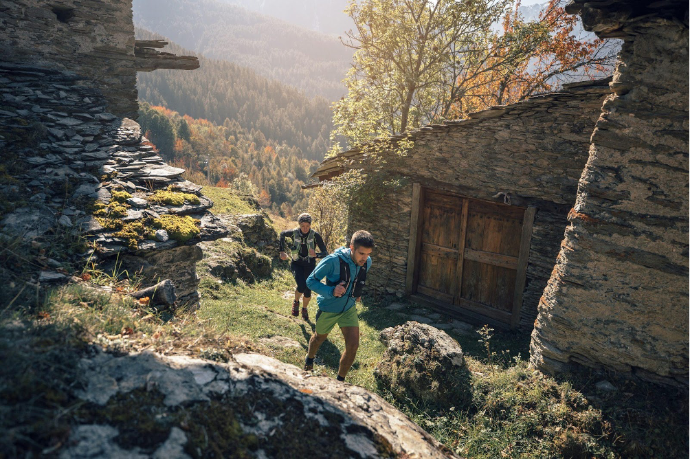 Trail runners running in ancient villages in Valle Maira