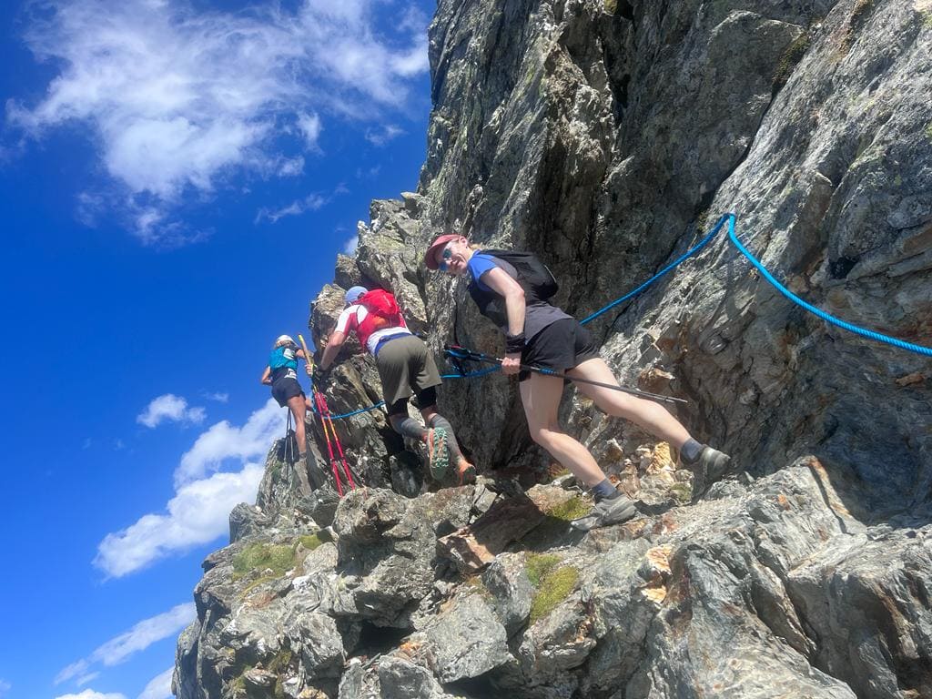 Ultra Trail Runners Ascend a Challenging Section of the Tor des Geants with Ropes Along the Rocky Path